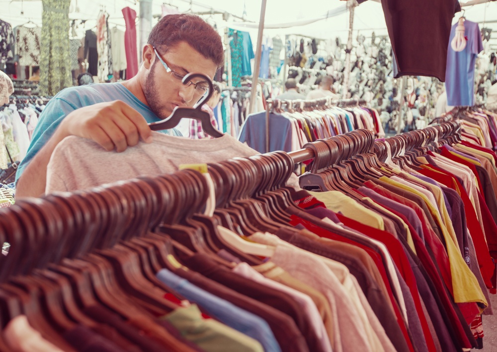 Young man buying in second hand store.jpeg
