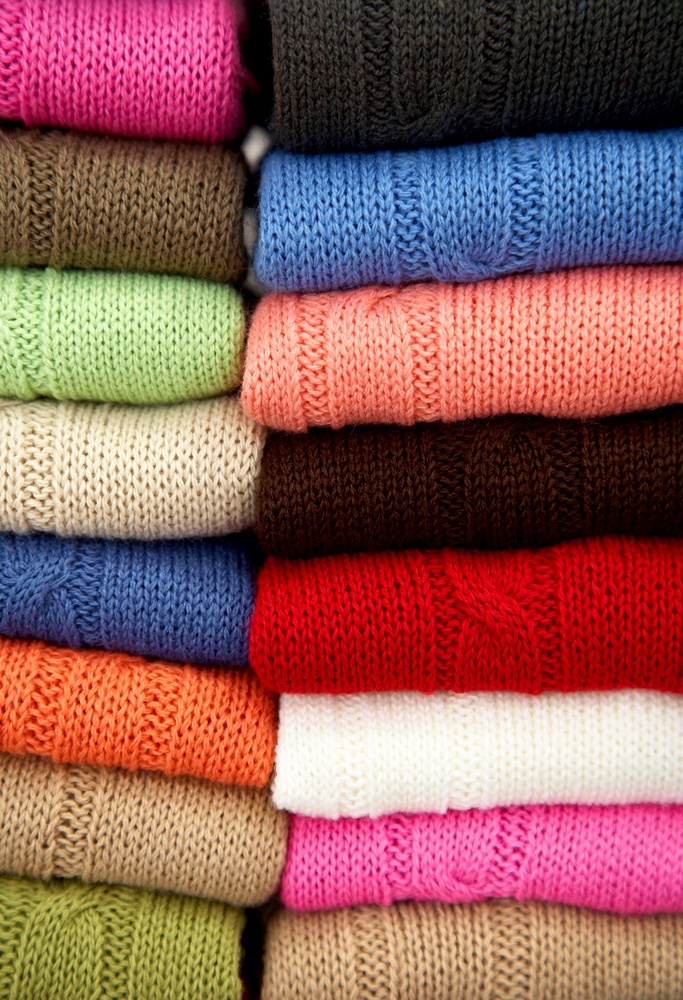 multi colour woolen sweaters in a retail store.jpeg